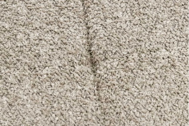 Repose-pieds moderne scandinave – Tissu bouclé champagner greige avec pieds en métal noir